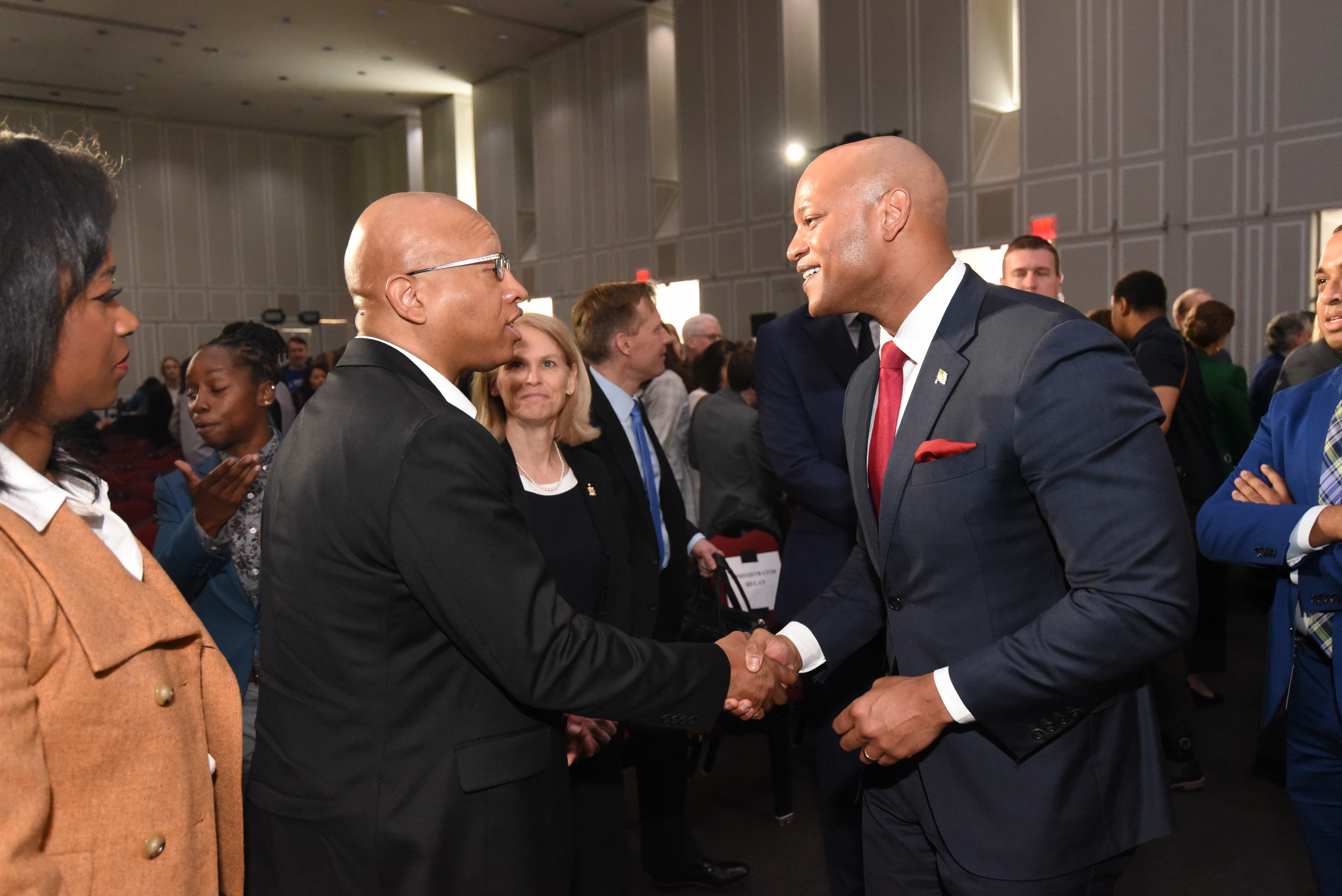 Dr. Sacoby Wilson shaking hands with Maryland Governor Wes Moore