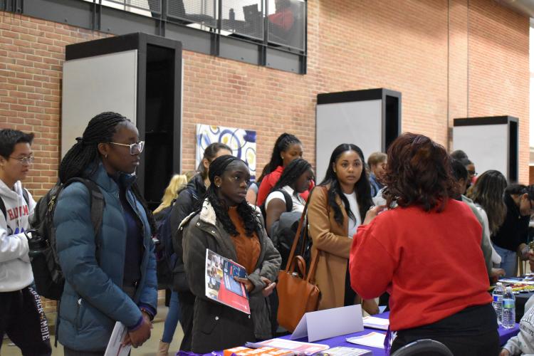 students visiting a booth at career expo