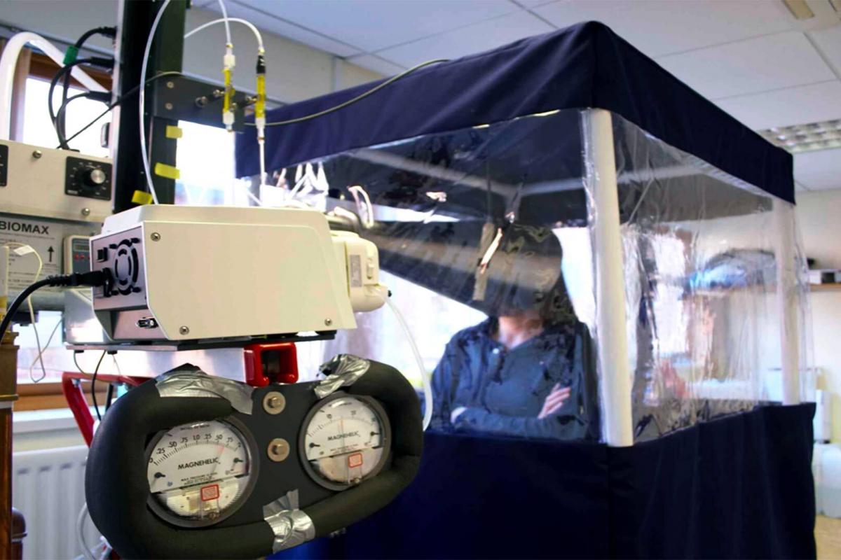 A quarantined participant in a flu virus transmission study breathes into a machine developed by UMD Professor Don Milton to measure virus content in breath.