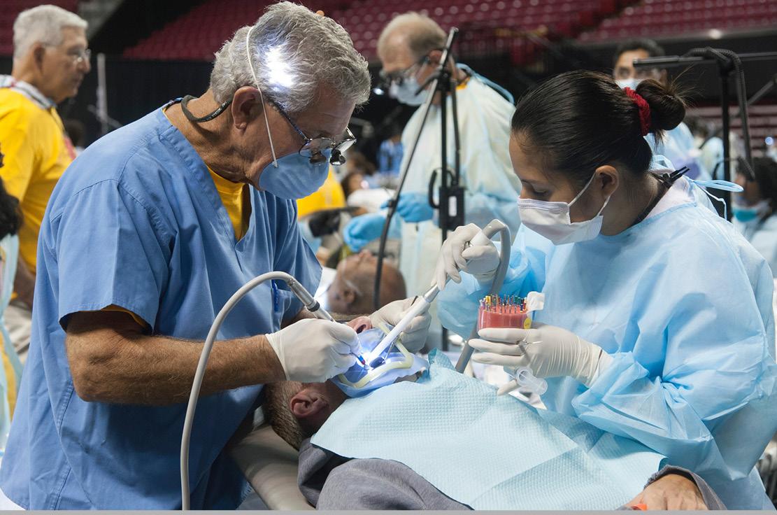 Mission of Mercy, dentist cleaning teeth.