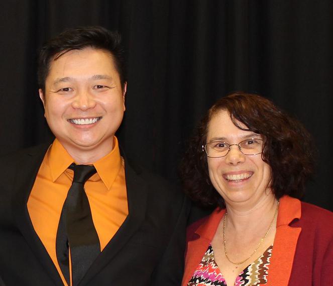Mariano Kanamori, Asian man wearing orange shirt, black tie and black suit, and Olivia Carter-Pokras, faculty member of the School of Public Health at the University of Maryland