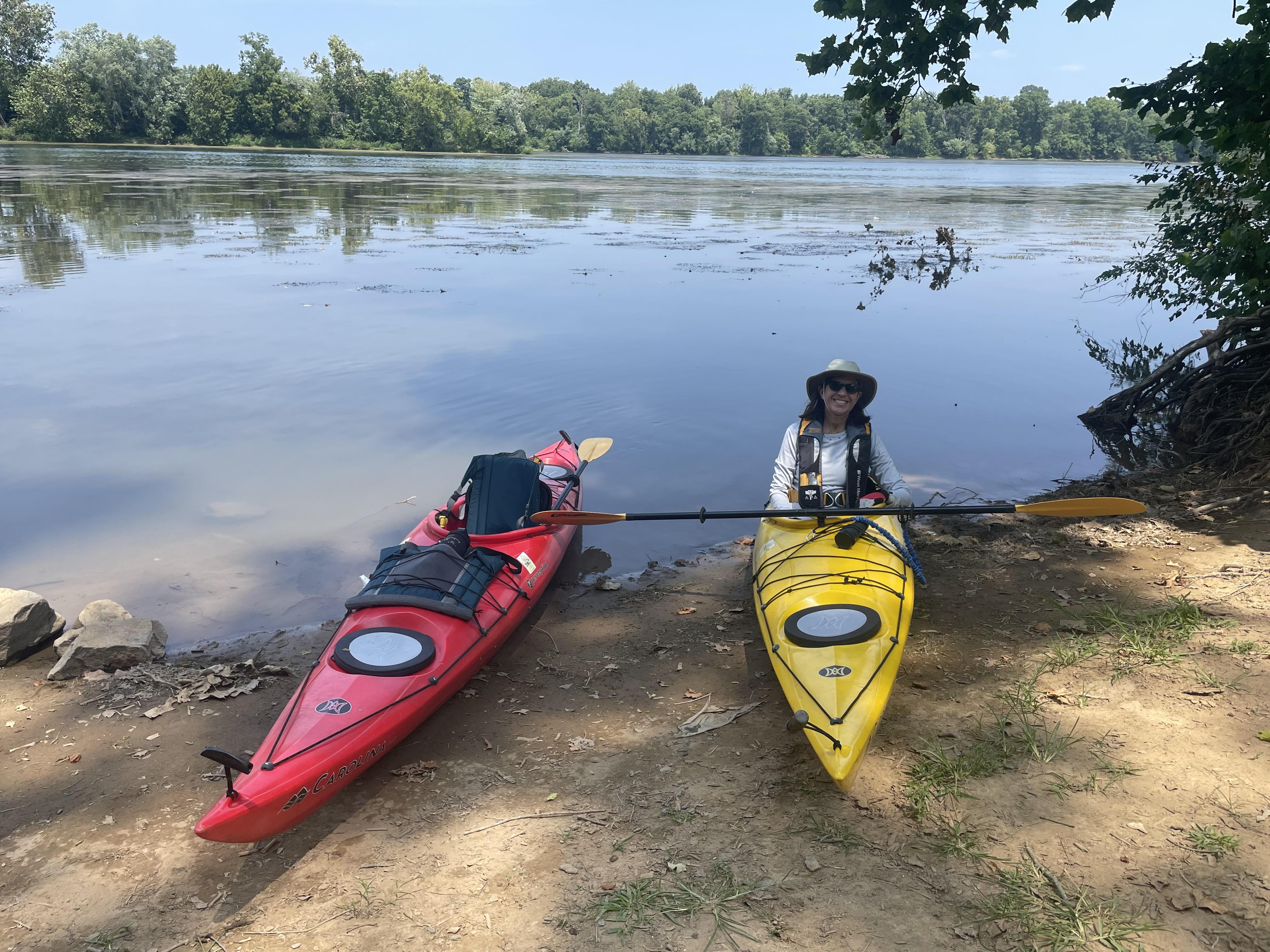 two kayaks on the shore with a person in one of them